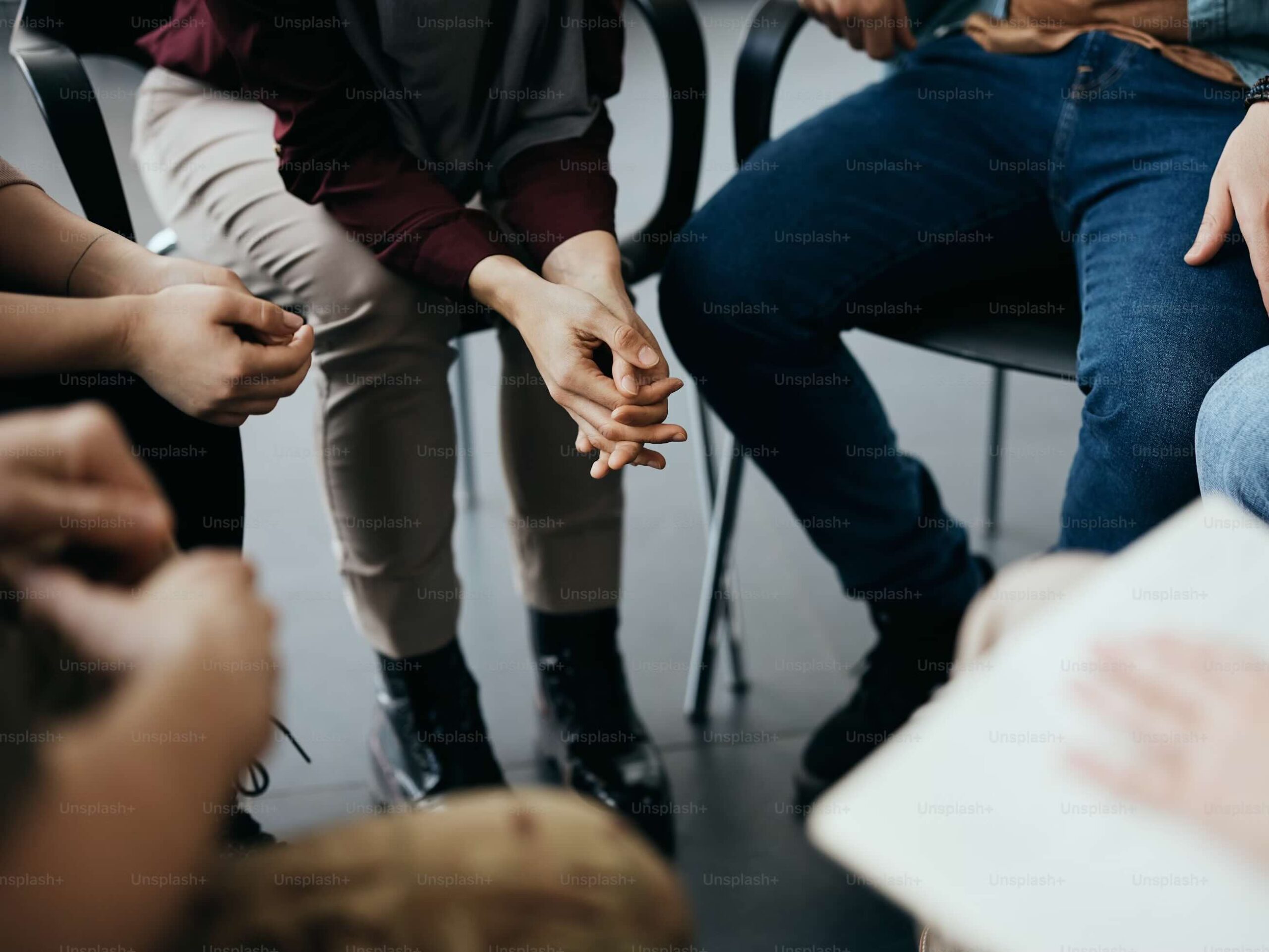 Close up of hands in a group therapy session