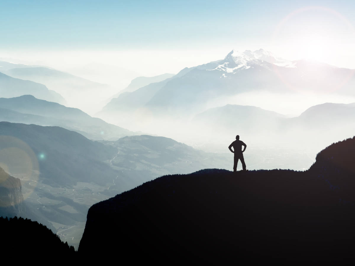 High achieving individual summiting a mountain after learning performance psychology skills